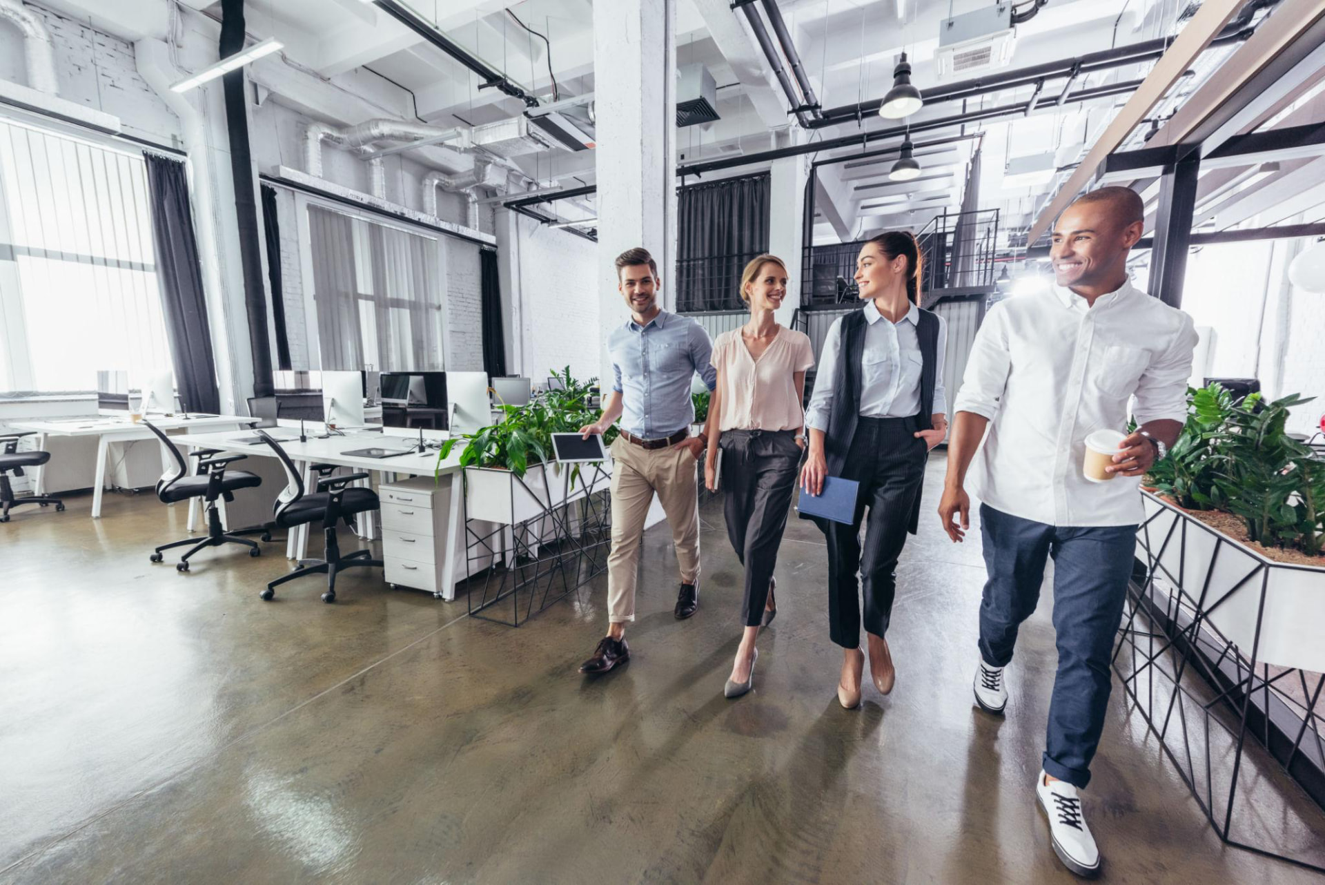 International colleagues walking together through a modern office